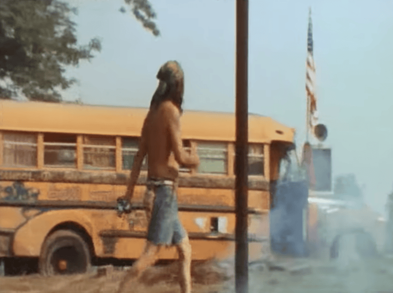 Man walks by school bus - Woodstock perimeter